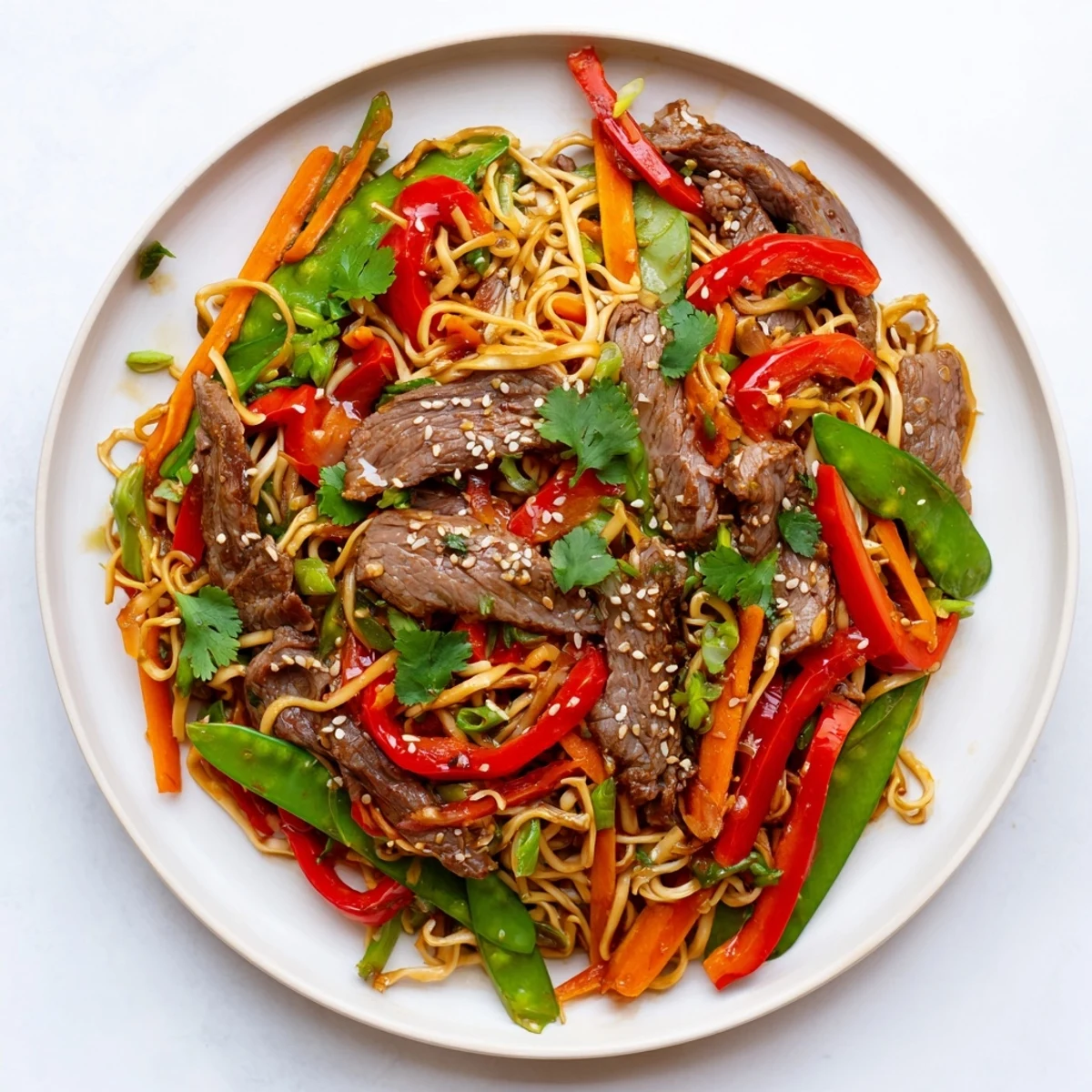 Sizzling beef strips, crisp vegetables, and noodles tossed in a spicy, umami-rich sauce in a hot wok.  