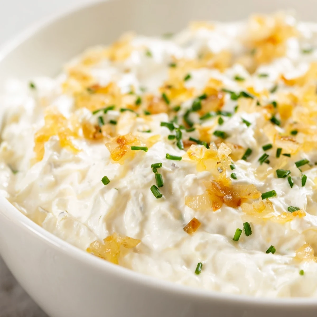Savory Game Day Onion Dip in a rustic bowl, with a generous scoop of onion-rich dip and sturdy potato chips.