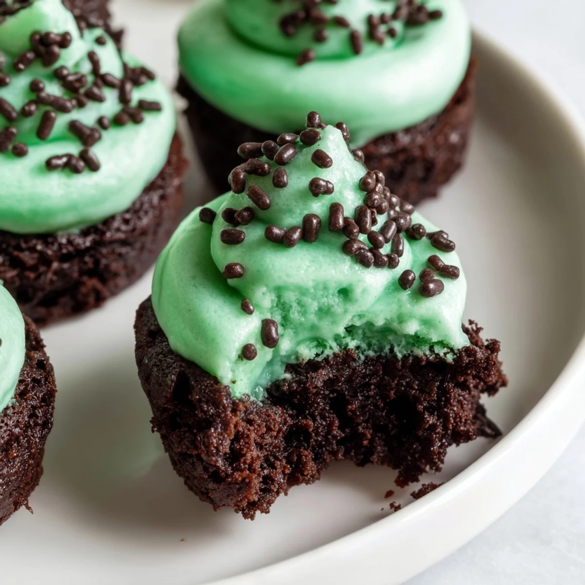 Freshly baked St. Patricks Day Mint Brownie Bites arranged on a plate, ready for a festive celebration.  