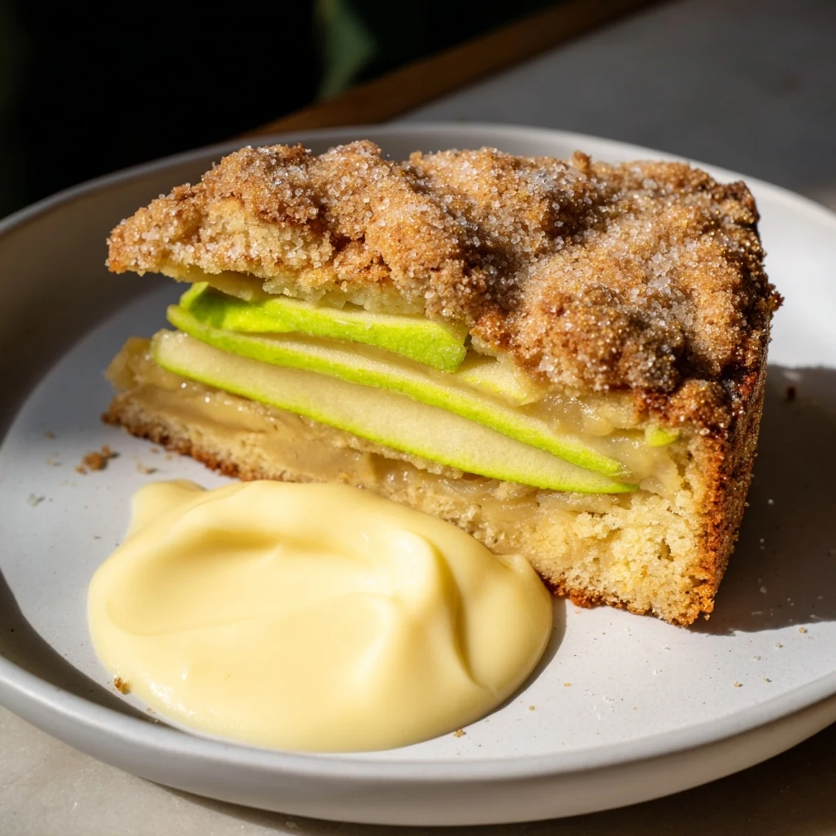 Freshly baked Irish Apple Cake with Vanilla Custard, served warm on a cozy dessert plate.