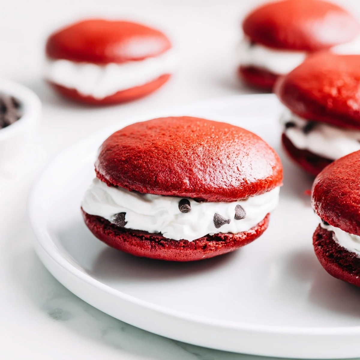 Freshly baked Red Velvet Whoopie Pies with marshmallow cream filling, ready to serve for a party.