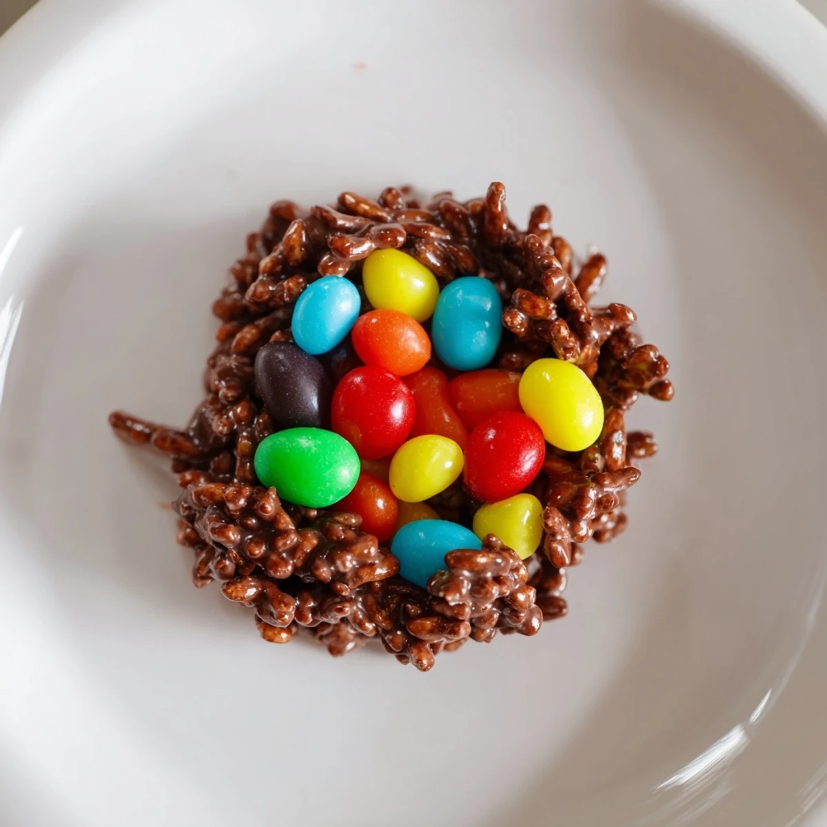Chocolate Easter Egg Nests with Jelly Beans displayed in a muffin tin, ready to serve as a festive spring dessert.