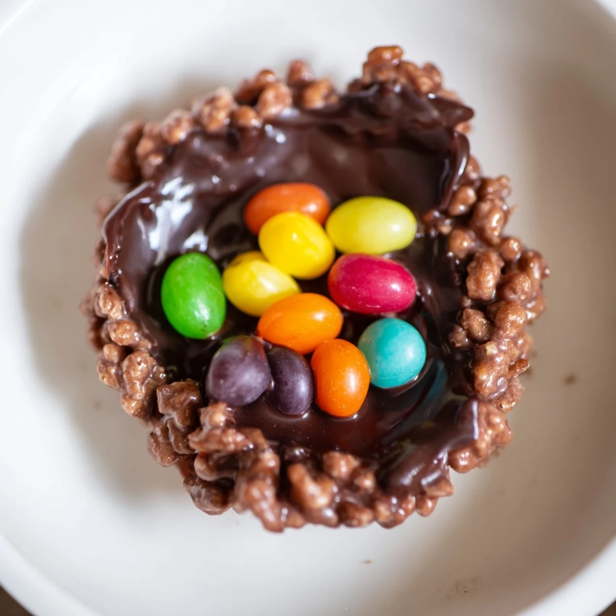 A close-up of Chocolate Easter Egg Nests with Jelly Beans on a pastel plate, perfect for an Easter dessert platter.