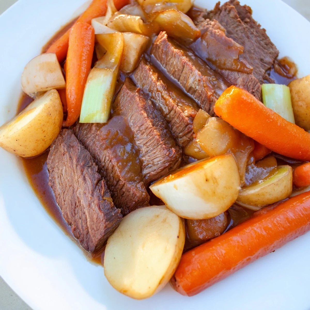 Slow Cooker Beef Pot Roast with Root Vegetables served in a bowl with crusty bread for dipping.
