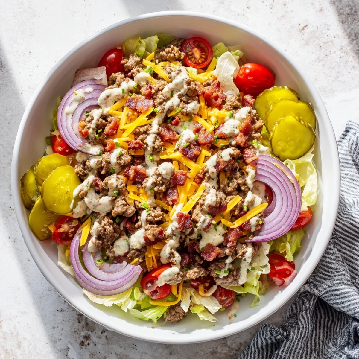 A close-up of a Smash Burger Bowl with seasoned beef, crisp lettuce, and tangy pickles.