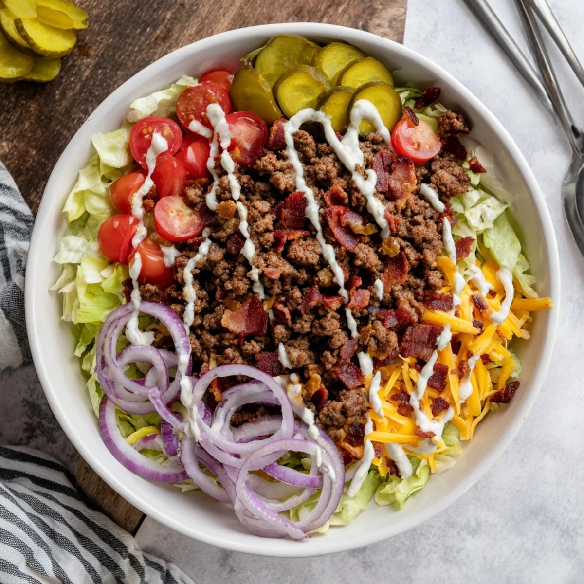 An overhead view of a colorful Smash Burger Bowl with fresh veggies and sesame seeds.