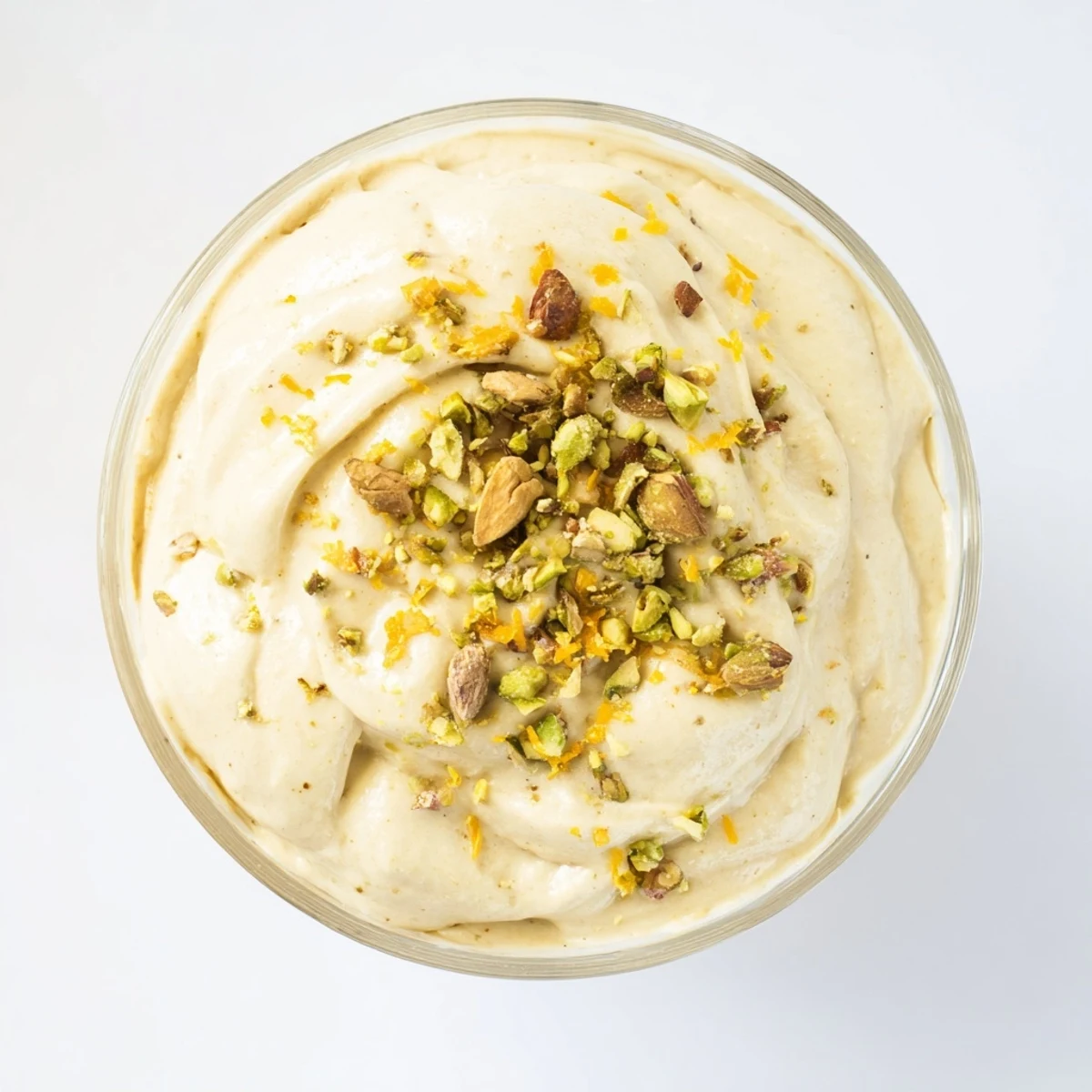 Airy sweet dessert swirled with date paste and orange blossom water in individual glass bowls