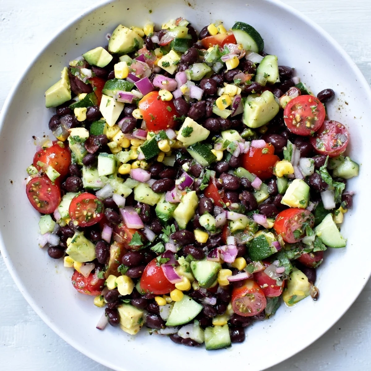 Zesty chopped black bean salad tossed with lime dressing and colorful garden vegetables