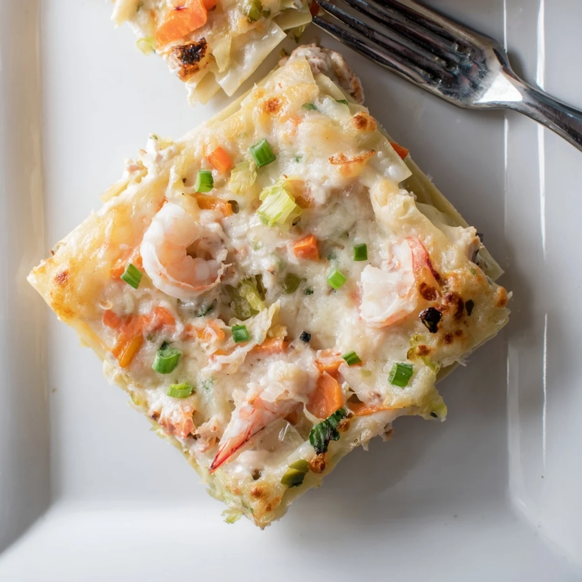 Golden bubbling shrimp dumpling lasagna with melted cheese and layered dumpling wrappers