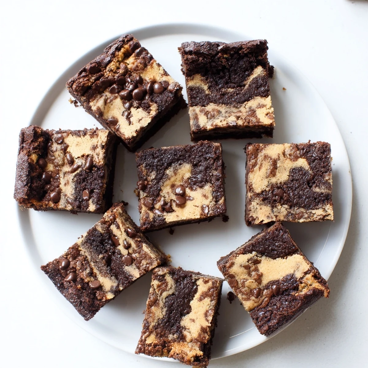 Homemade fudgy chewy browkies cut into squares displaying rich marbled brownie and cookie dough texture