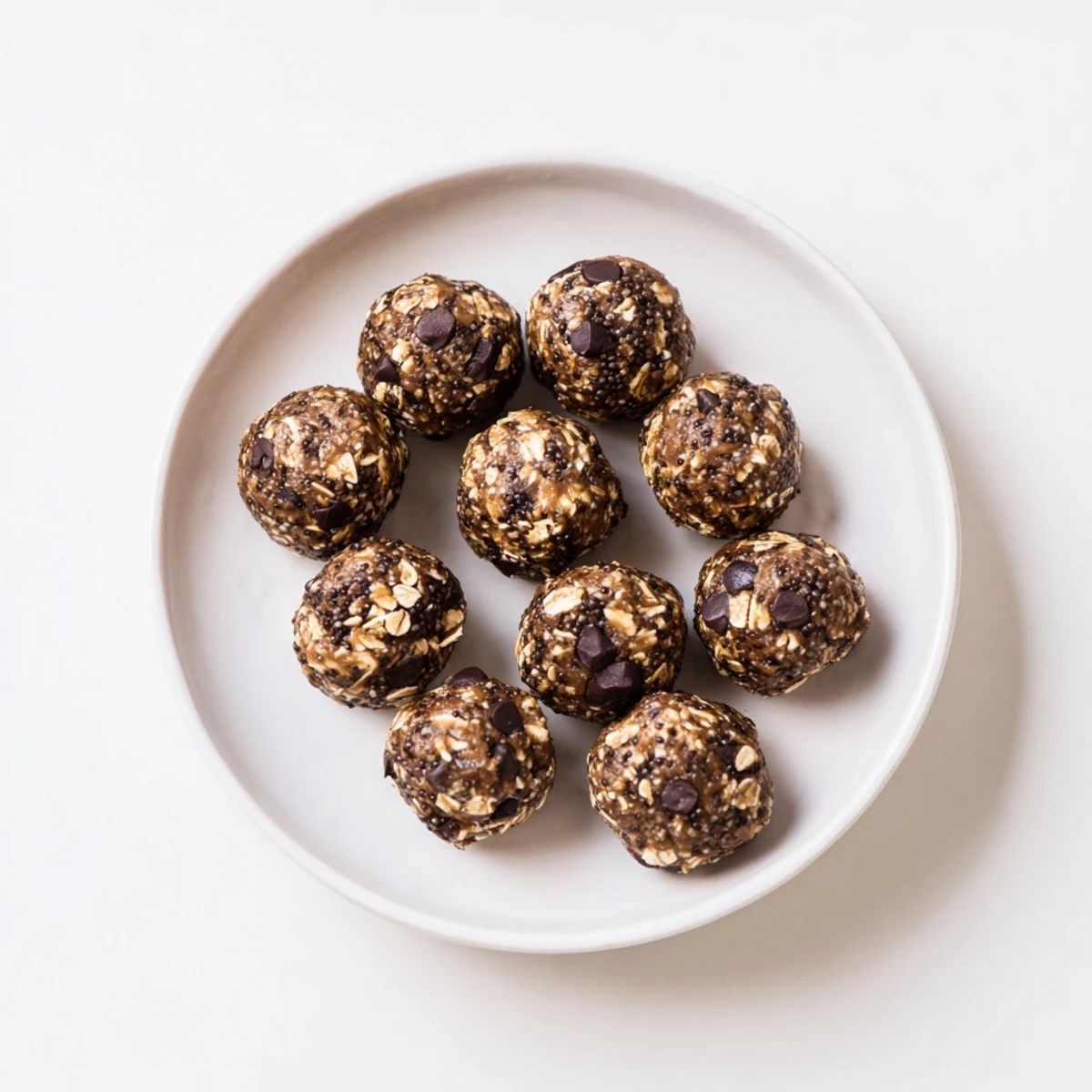 Rich chocolate peanut butter protein balls arranged on a parchment lined baking sheet, ready for healthy snacking