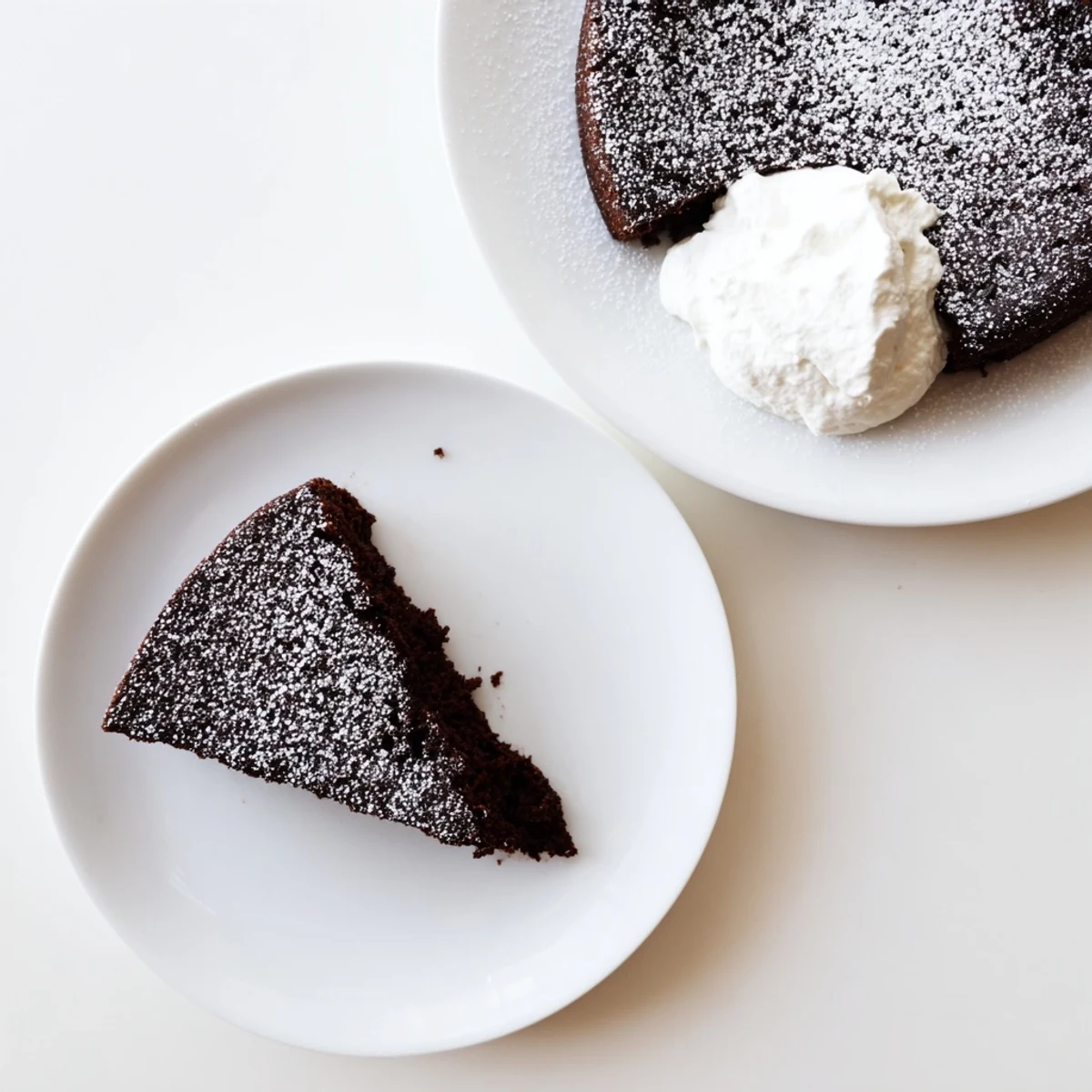 Moist Guinness chocolate cake baked in air fryer with dusted powdered sugar topping on serving plate