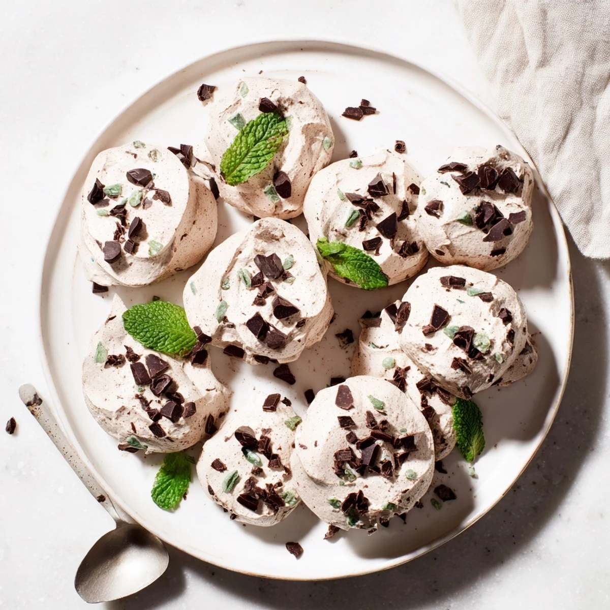 Dreamy dark chocolate and mint chip clouds piled on a white serving plate