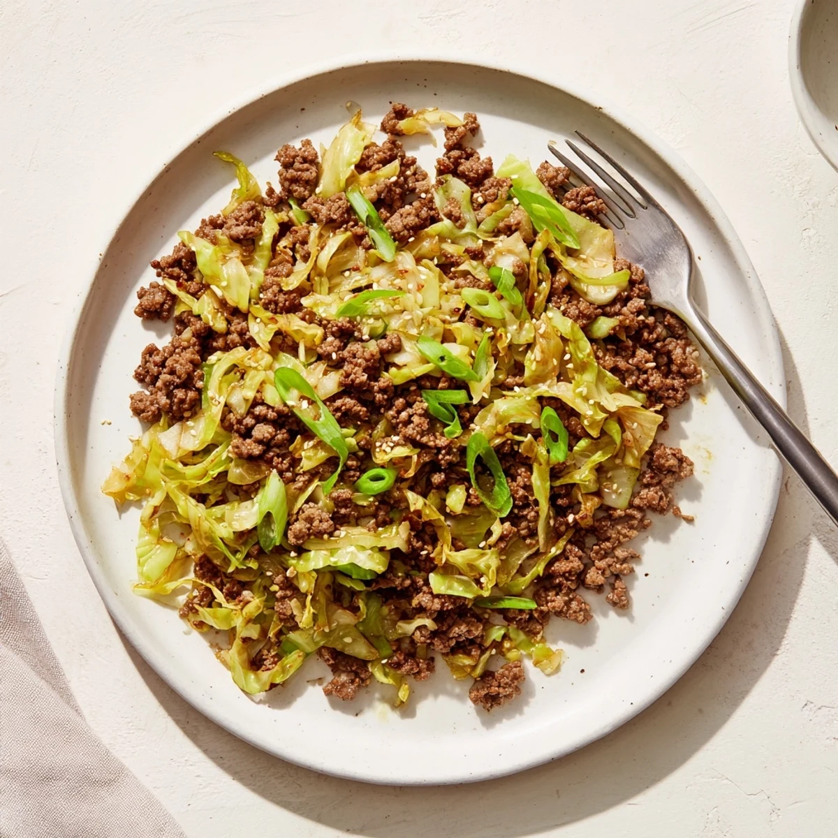 Savory Asian-inspired stir fry of seasoned beef and crisp cabbage in rich sauce
