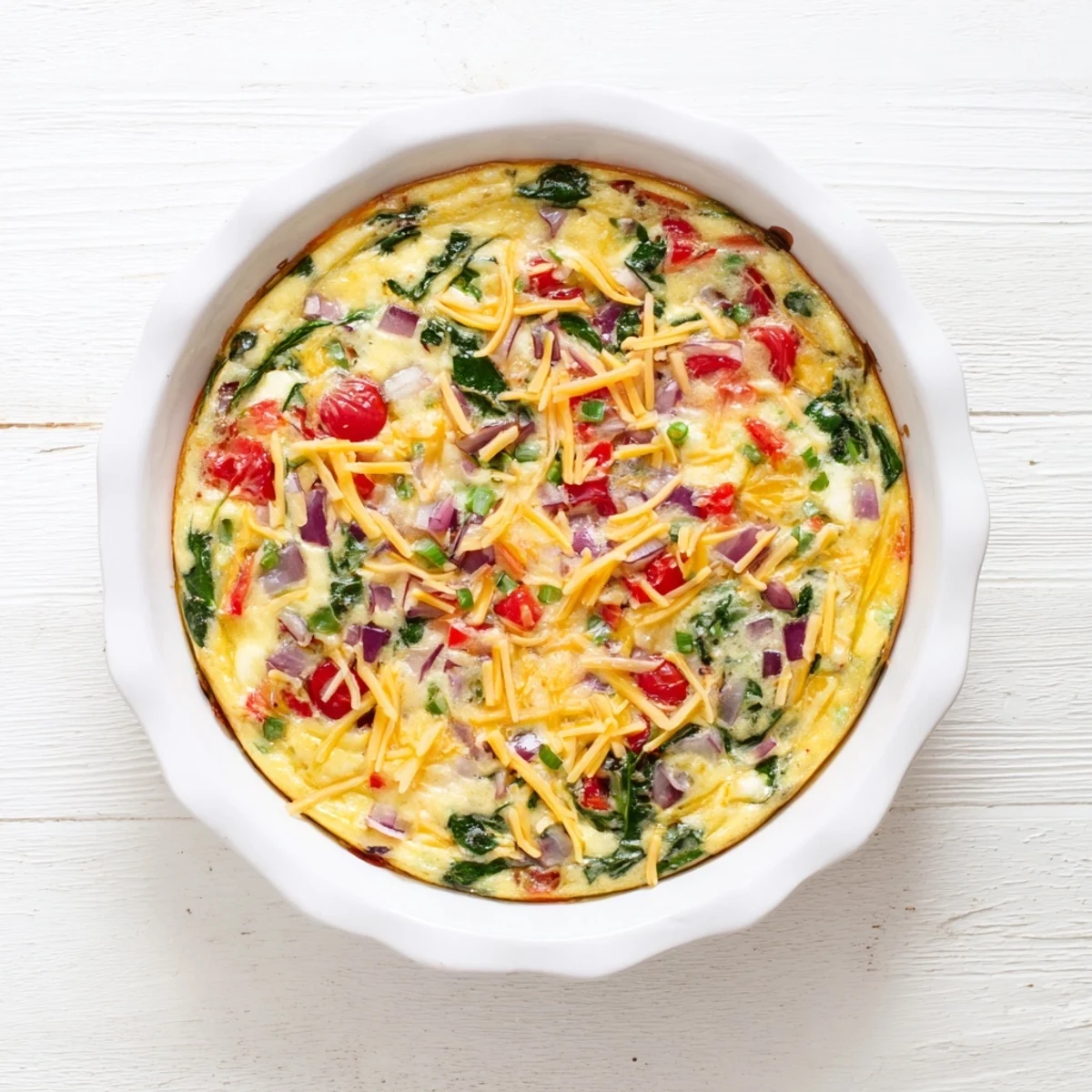 Protein-packed healthy crustless quiche with fresh vegetable filling and feta cheese ready for brunch