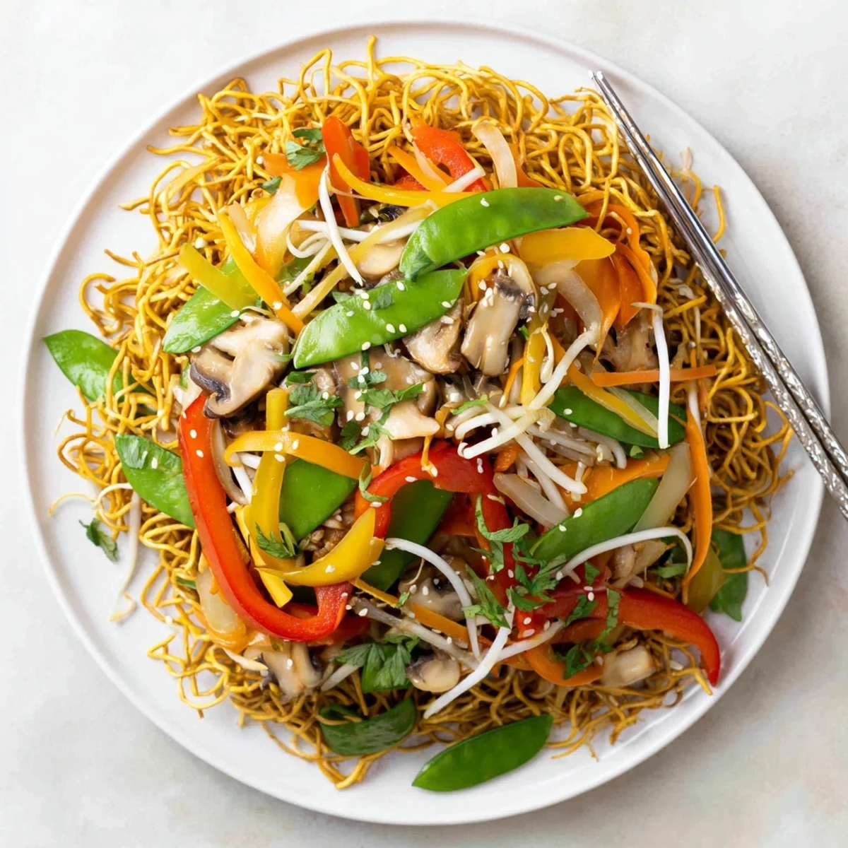 Vibrant vegetable stir-fry served over crispy fried chow mein noodles in a tangy glaze