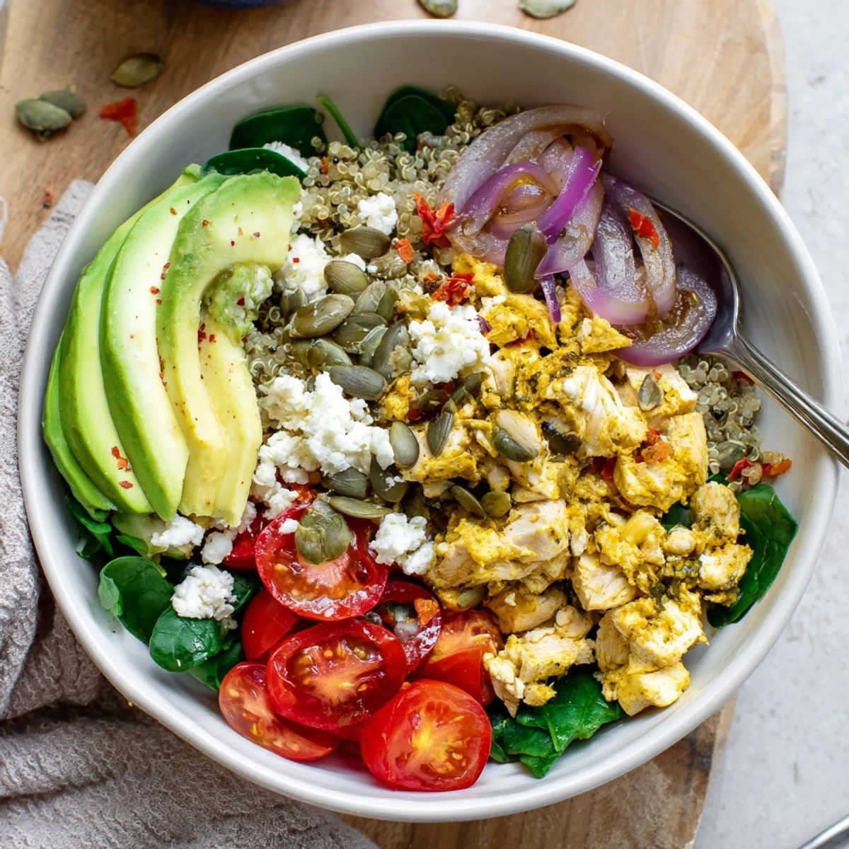 Colorful easy high protein breakfast bowl with scrambled eggs, fresh vegetables, and creamy avocado slices