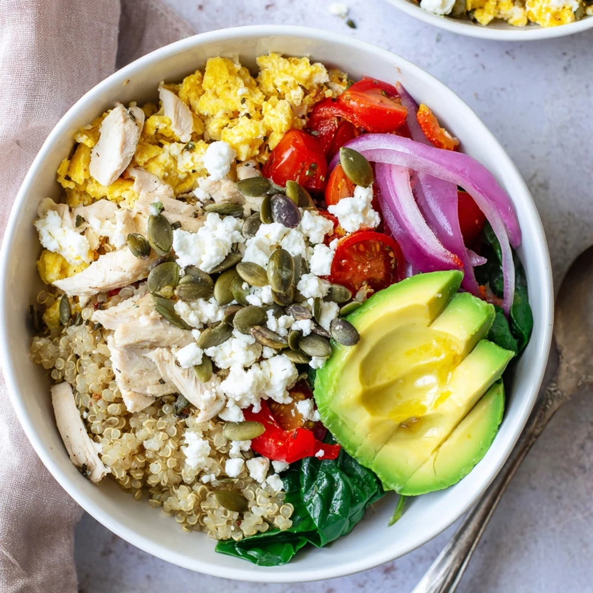 Savory easy high protein breakfast bowl topped with cottage cheese scrambled eggs, spinach, and cherry tomatoes