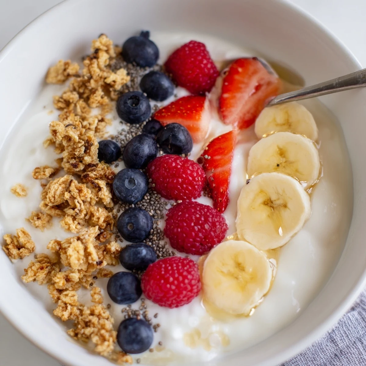 Cottage Cheese Breakfast Bowl with vibrant berries, crunchy granola, and honey drizzle.