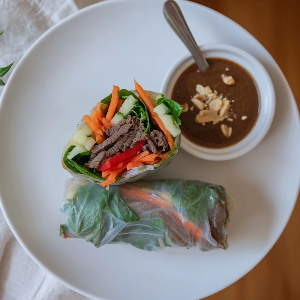 Sliced Thai Basil Beef Rolls arranged on platter, served with spicy peanut dipping sauce  