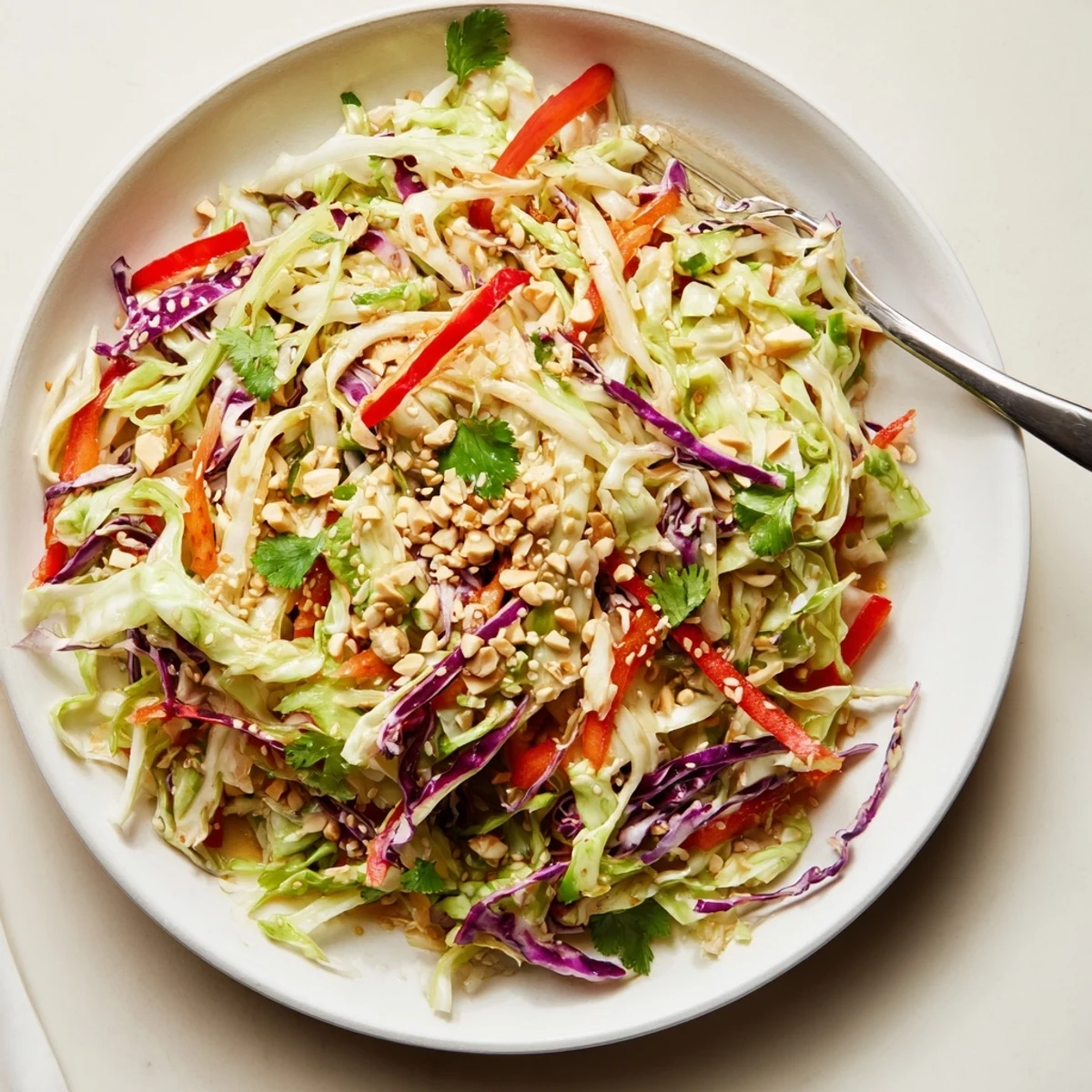 Colorful Asian Cabbage Salad tossed in tangy sesame ginger dressing ready to serve