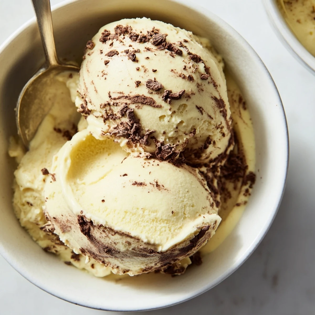Creamy banana nice cream scooped into a bowl topped with fresh banana slices and a sprinkle of cinnamon