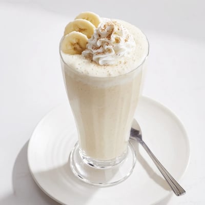 Cold Vanilla Banana Shake garnished with banana slices and cinnamon sprinkle
