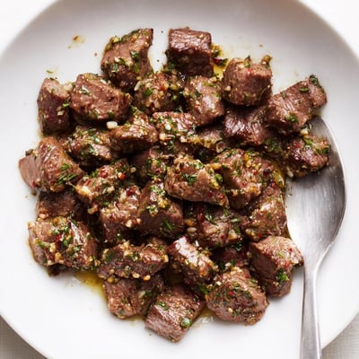 Rustic Cowboy Butter Steak Bites Recipe piled on a board, aromatic and buttery.